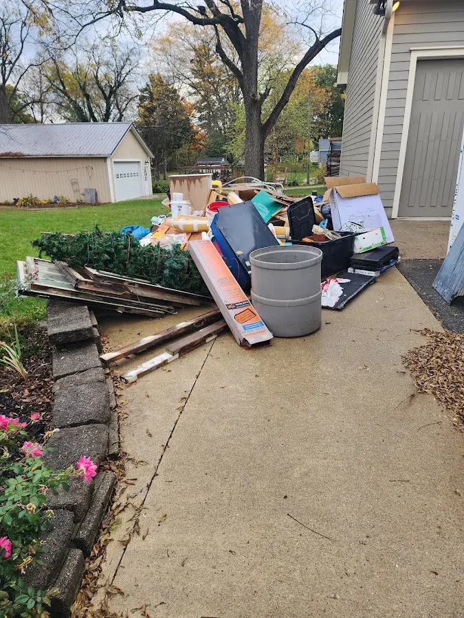 Dumpster being loaded with debris for 12 Yard Dumpster Rental in St. Joseph